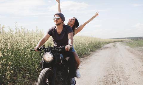 Happy Millennials enjoying nature on a scooter