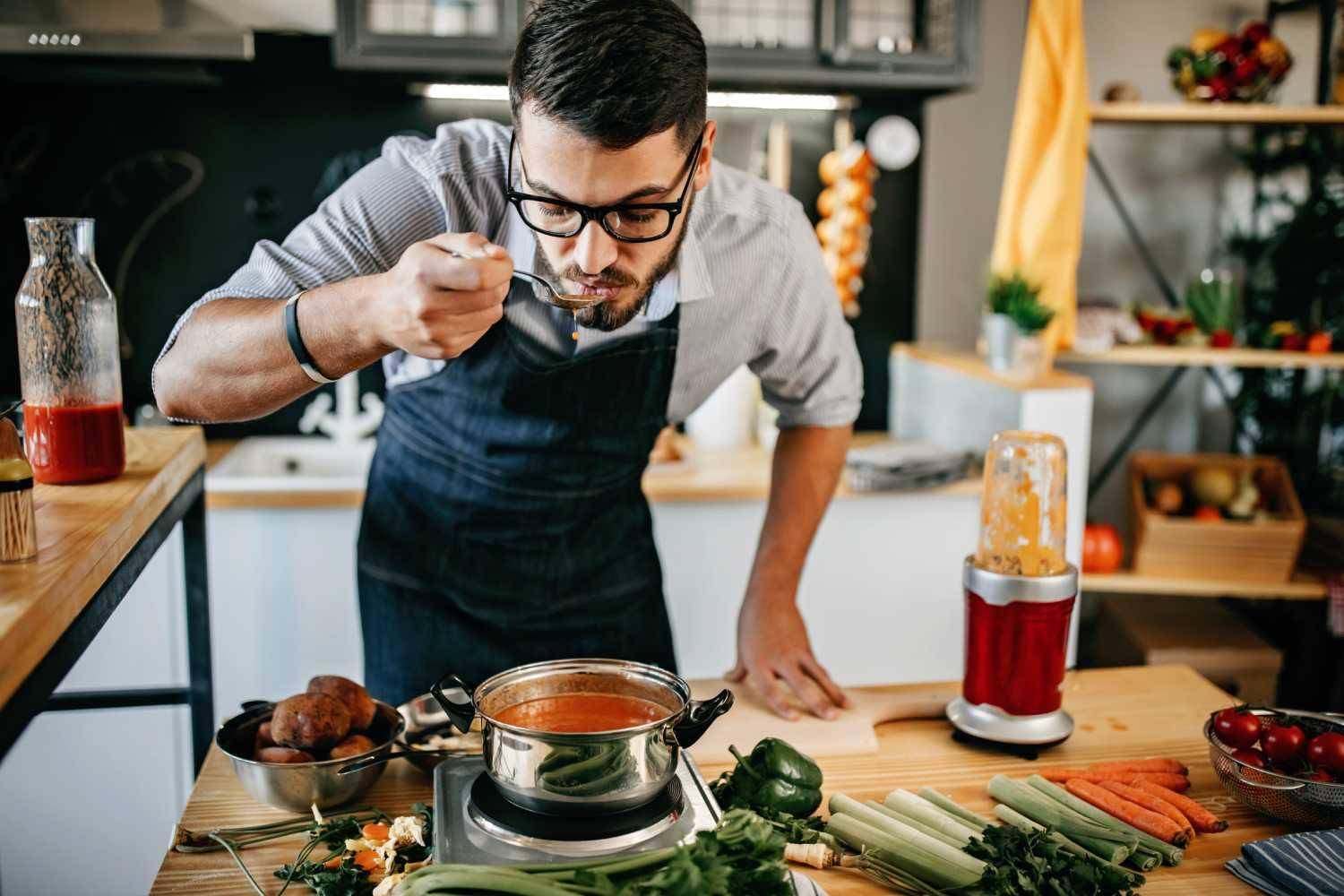 man tasting food from a spoon