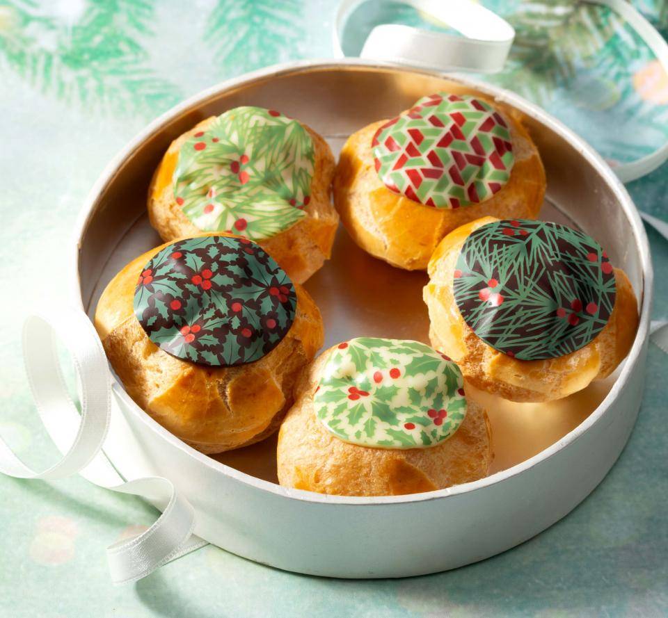 profiteroles decorated with molten chocolate holly leaf christmas designs
