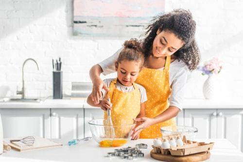 woman baking with child
