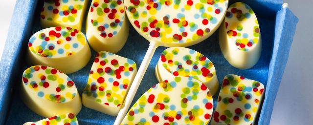 Chocolate pralines and lollipops with a colorful dotted print