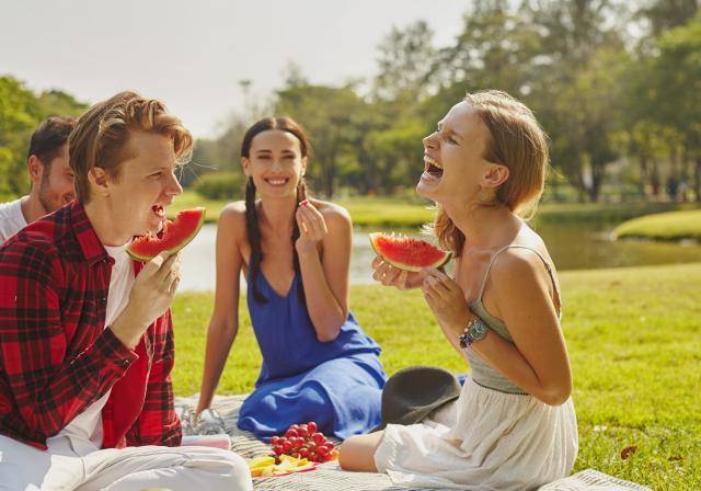 Group of young people enjoying a healthy picnic
